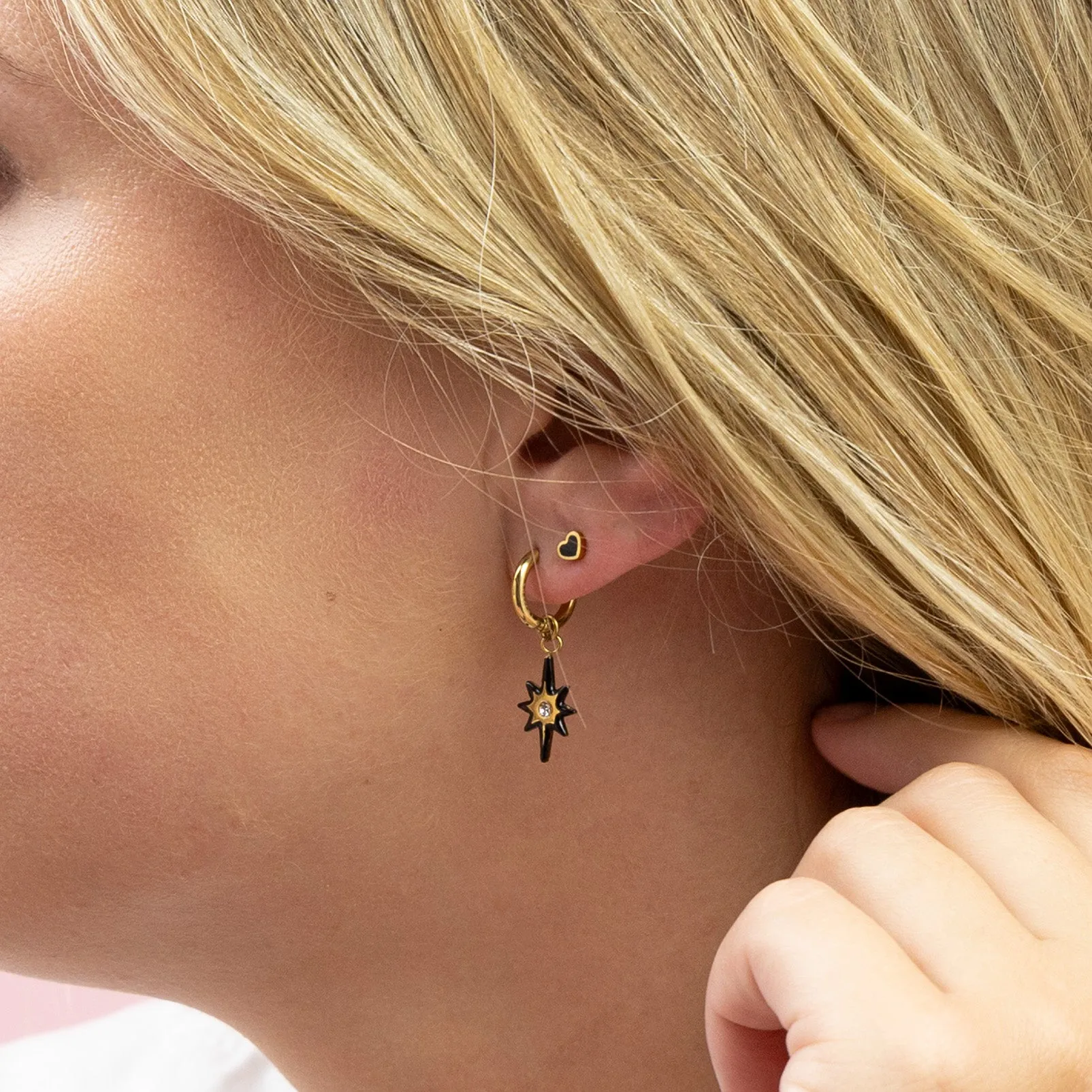 Gold coloured hoop earring with black star charm